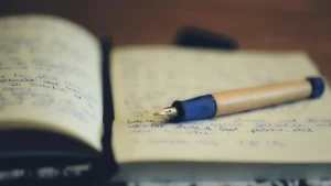 Journaling for mental health, a photo of a journal with a fountain pen.